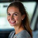Portrait of a happy client, Eleanor R. enjoying her new electric car.